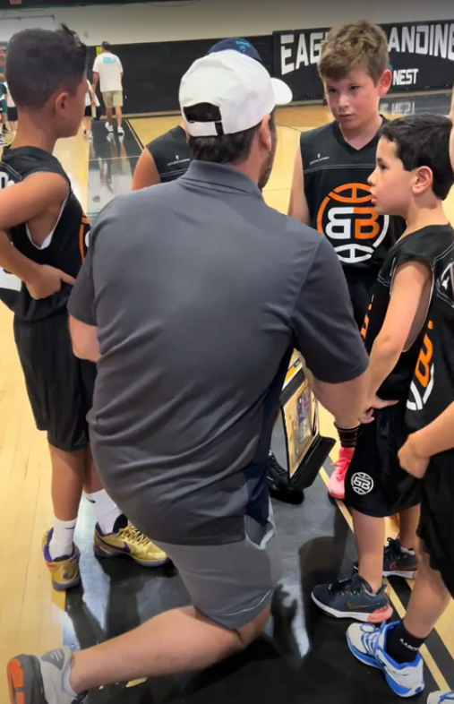Boca Basketball volunteer coach in a huddle with his girls team